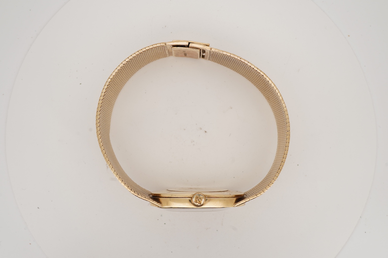 A gentleman's early 1970's 9ct gold Bueche Girod manual wind dress wrist watch, on an integral 9ct gold bark effect bracelet